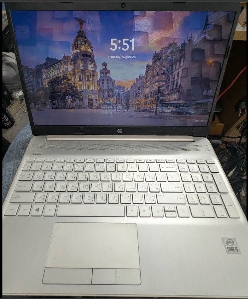Repaired white HP laptop powered on and running Windows