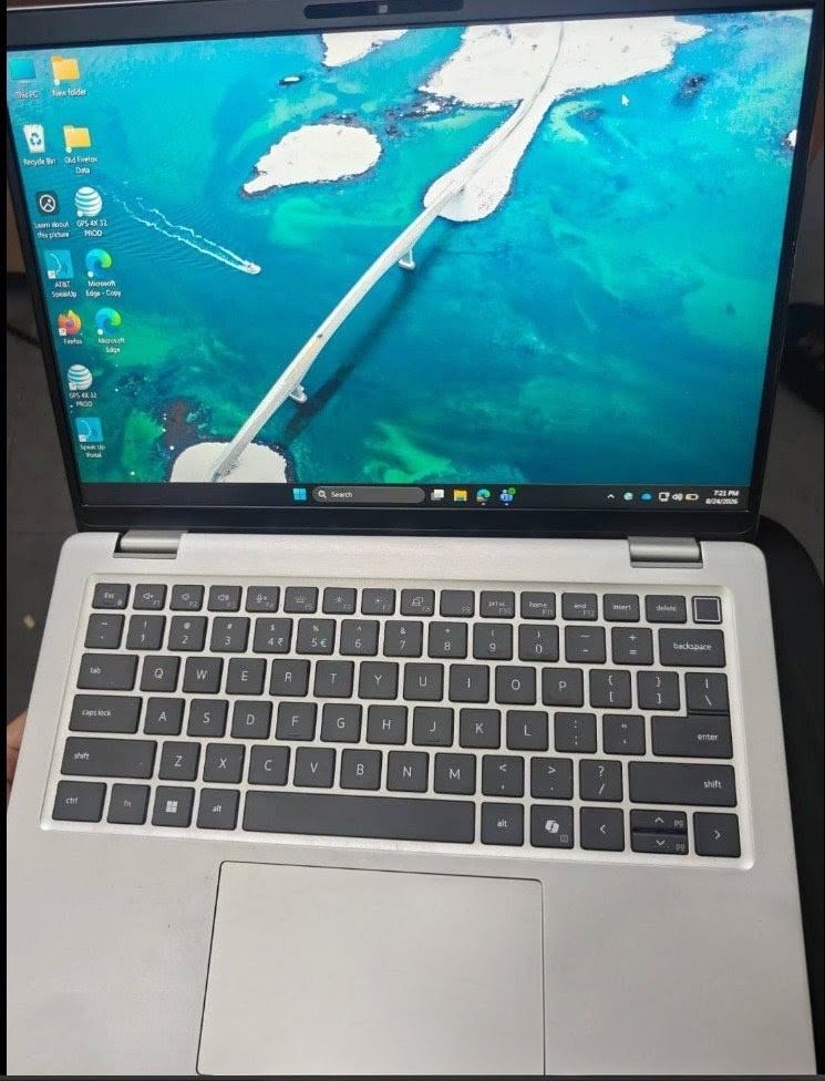 Silver Dell laptop open on the Windows desktop, ready for handover